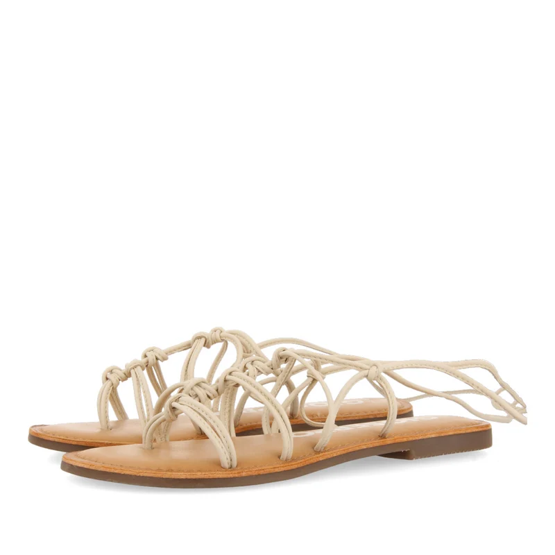 Mambai women's flat off-white leather sandals with thin straps and decorative knots