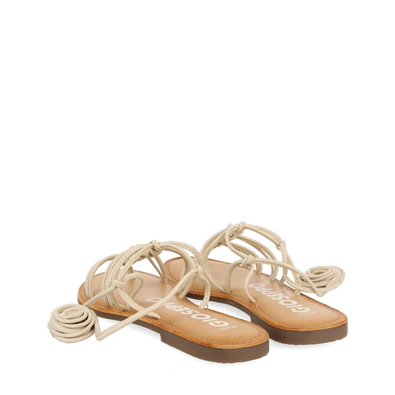 Mambai women's flat off-white leather sandals with thin straps and decorative knots
